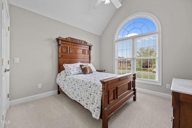 bedroom with baseboards, light carpet, a ceiling fan, and lofted ceiling