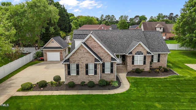 view of front facade featuring fence private yard, a garage, a front lawn, brick siding, and driveway
