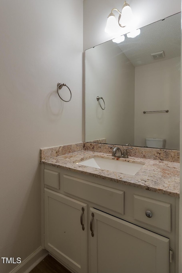 805 Penncross Dr, Raleigh, NC 27610 - half bathroom with vanity, a chandelier, and toilet