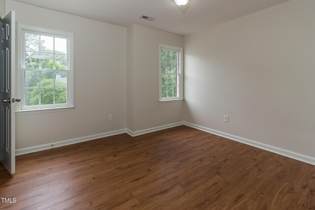 805 Penncross Dr, Raleigh, NC 27610 - empty room with dark wood-style flooring and baseboards