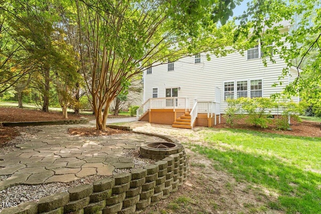 rear view of property with a patio area, an outdoor fire pit, a wooden deck, and stairs