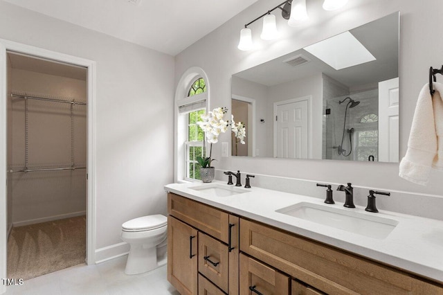 bathroom featuring a sink, a shower stall, toilet, and visible vents