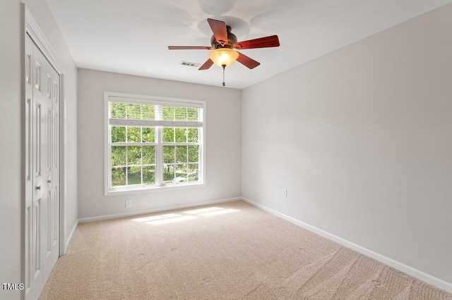 unfurnished bedroom featuring carpet flooring, baseboards, visible vents, and a closet