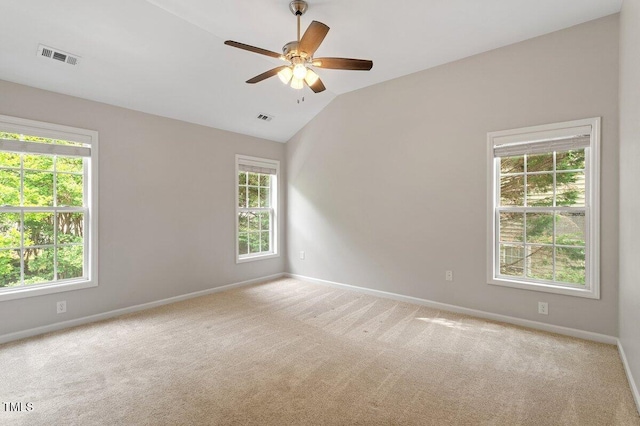 carpeted spare room with visible vents and baseboards