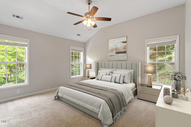 bedroom featuring visible vents, vaulted ceiling, and light colored carpet