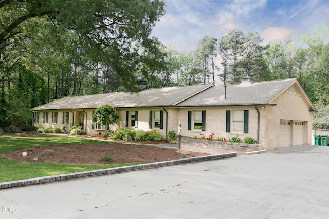 11 Pine Forest Dr, Siler City, NC 27344 - ranch-style home with a chimney, driveway, a garage, brick siding, and roof with shingles