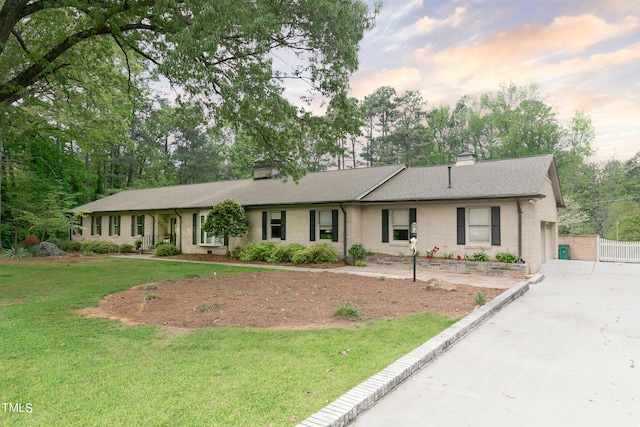11 Pine Forest Dr, Siler City, NC 27344 - single story home featuring a chimney, brick siding, driveway, and a lawn