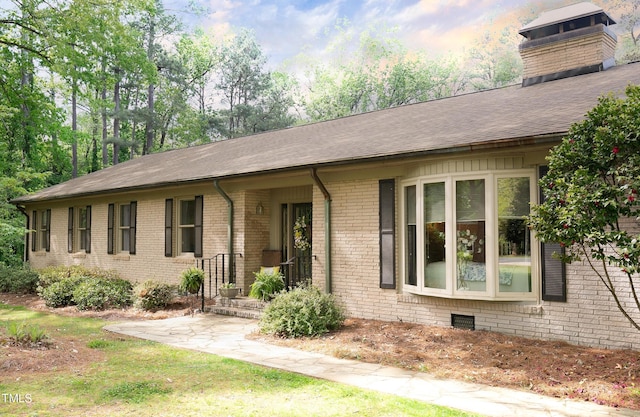 11 Pine Forest Dr, Siler City, NC 27344 - single story home with a chimney, brick siding, and a shingled roof