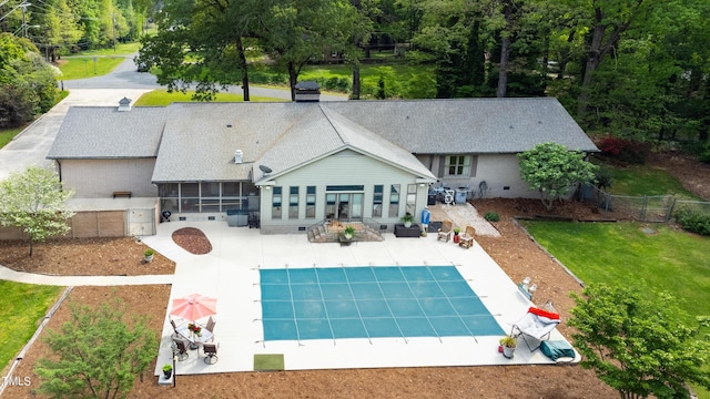 11 Pine Forest Dr, Siler City, NC 27344 - rear view of house featuring a shingled roof, a fenced backyard, a patio, a fenced in pool, and a sunroom