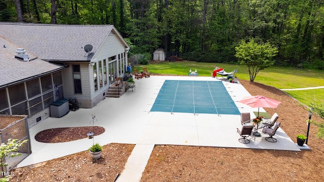 11 Pine Forest Dr, Siler City, NC 27344 - view of swimming pool with a storage unit, a covered pool, a yard, a sunroom, and a patio