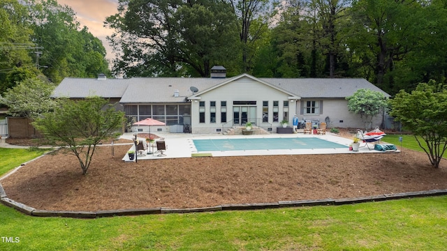 11 Pine Forest Dr, Siler City, NC 27344 - rear view of house with a covered pool, a yard, a sunroom, crawl space, and a patio