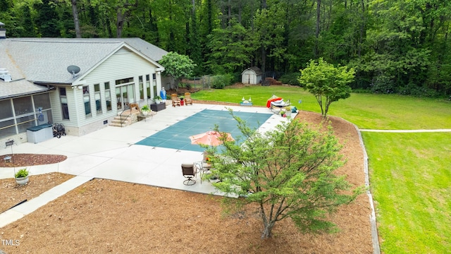 11 Pine Forest Dr, Siler City, NC 27344 - view of swimming pool with a storage unit, a patio area, an outdoor structure, a yard, and a sunroom