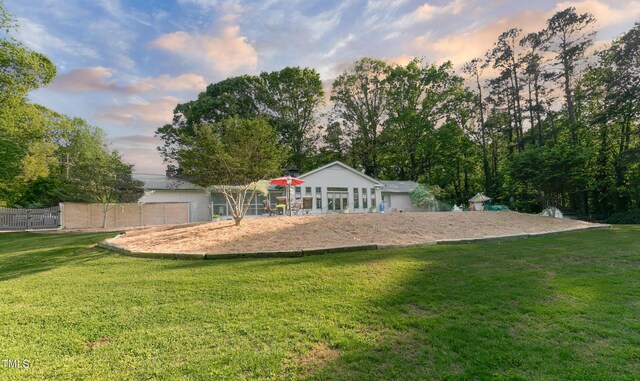 11 Pine Forest Dr, Siler City, NC 27344 - back of property at dusk featuring fence and a yard