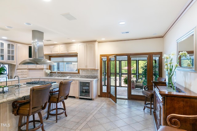 11 Pine Forest Dr, Siler City, NC 27344 - kitchen featuring wine cooler, island range hood, and a healthy amount of sunlight