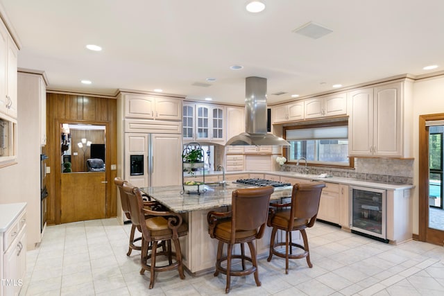 11 Pine Forest Dr, Siler City, NC 27344 - kitchen featuring island exhaust hood, backsplash, wine cooler, and a breakfast bar area