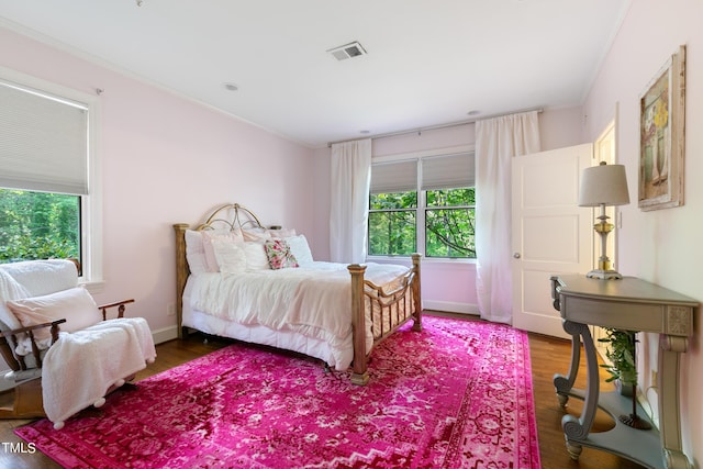 11 Pine Forest Dr, Siler City, NC 27344 - bedroom with crown molding, wood finished floors, visible vents, and multiple windows
