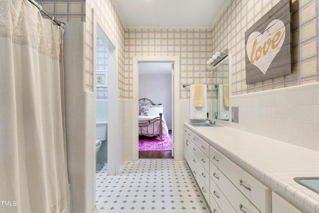 11 Pine Forest Dr, Siler City, NC 27344 - bathroom with a sink, double vanity, toilet, tile walls, and connected bathroom