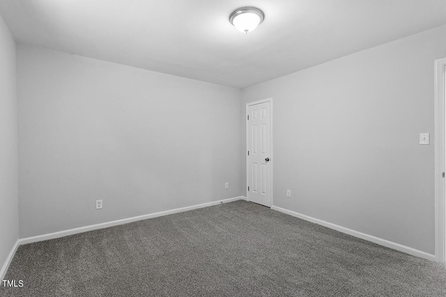 empty room with baseboards and carpet floors