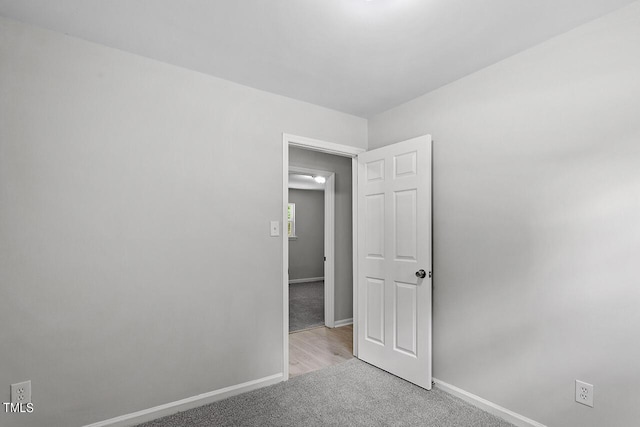 unfurnished bedroom featuring carpet and baseboards