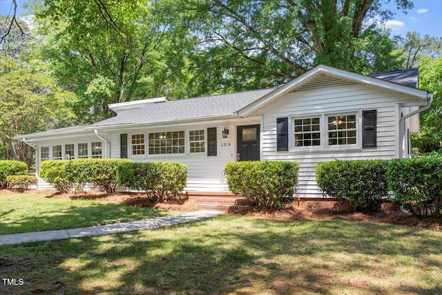 ranch-style home with a front lawn
