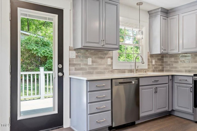kitchen featuring a sink, dishwasher, light countertops, backsplash, and gray cabinetry