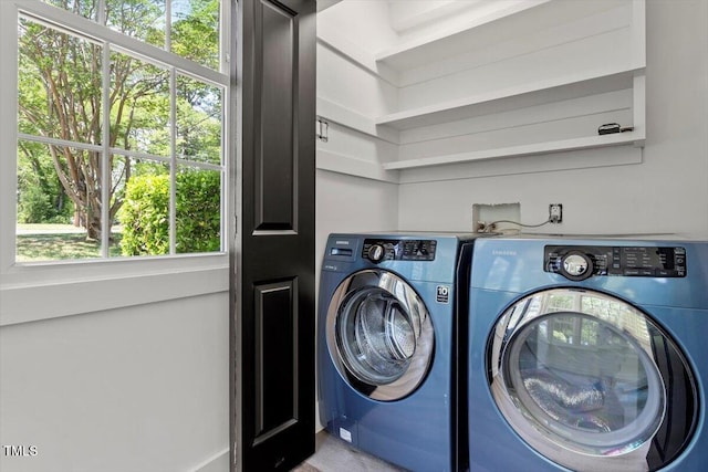 laundry room with laundry area and washing machine and clothes dryer