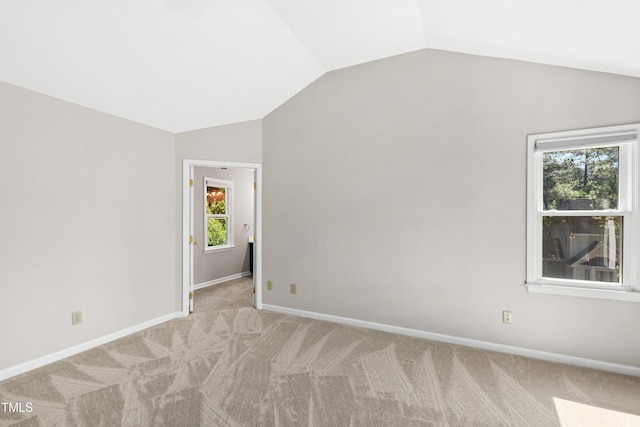 interior space with carpet floors, baseboards, and lofted ceiling