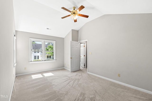 unfurnished bedroom featuring visible vents, lofted ceiling, light carpet, baseboards, and a ceiling fan
