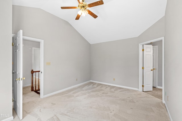 unfurnished bedroom with light colored carpet, baseboards, vaulted ceiling, and ceiling fan