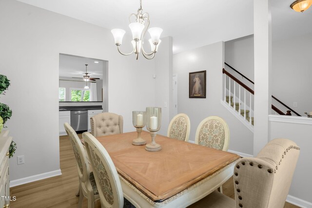 1305 Montreux Ct, Mebane, NC 27302 - dining room featuring baseboards, stairway, wood finished floors, and ceiling fan with notable chandelier