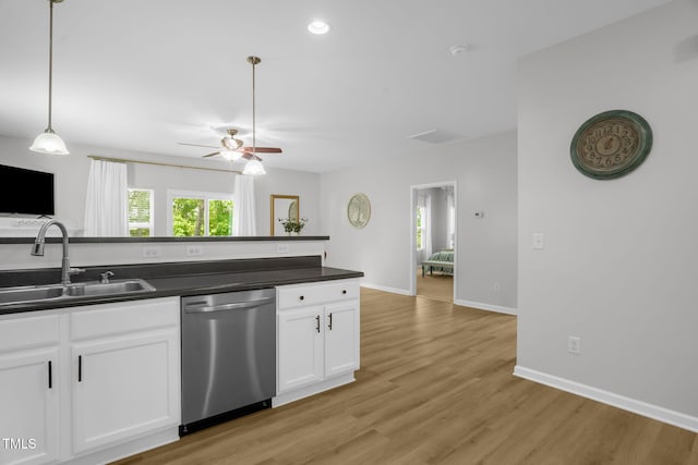 1305 Montreux Ct, Mebane, NC 27302 - kitchen featuring white cabinets, a sink, dark countertops, dishwasher, and a ceiling fan