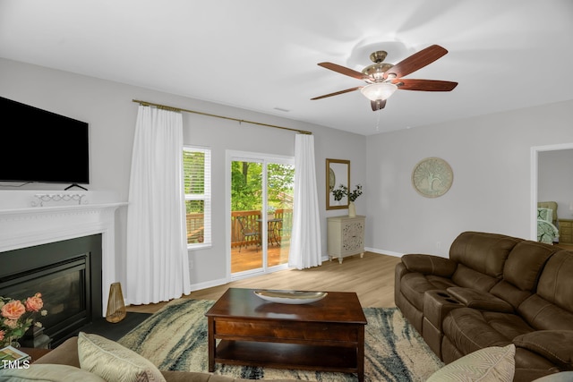 1305 Montreux Ct, Mebane, NC 27302 - living room with ceiling fan, a fireplace with flush hearth, wood finished floors, and baseboards