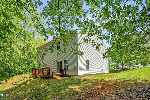 1305 Montreux Ct, Mebane, NC 27302 - rear view of property featuring a lawn and a wooden deck