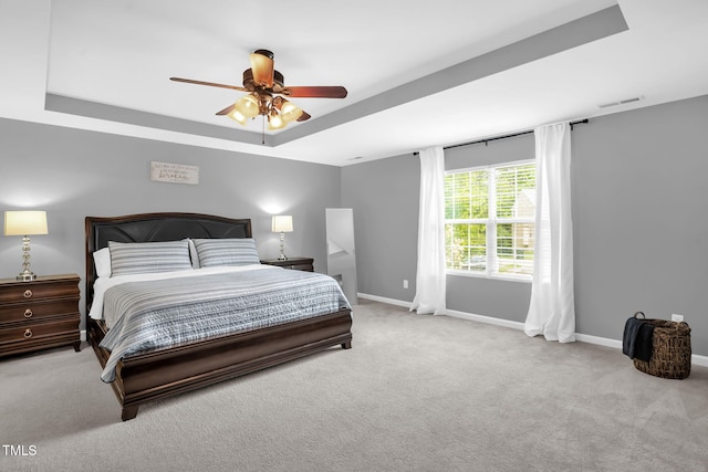 1305 Montreux Ct, Mebane, NC 27302 - carpeted bedroom with visible vents, ceiling fan, a tray ceiling, and baseboards