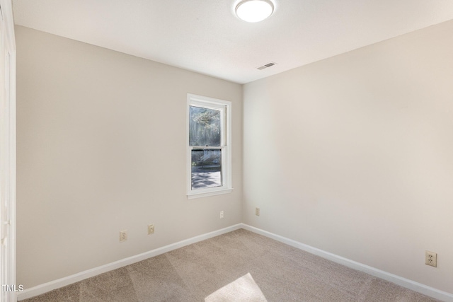 carpeted empty room with baseboards and visible vents