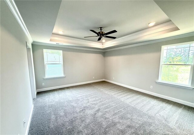 unfurnished room featuring ceiling fan, carpet floors, crown molding, and a tray ceiling