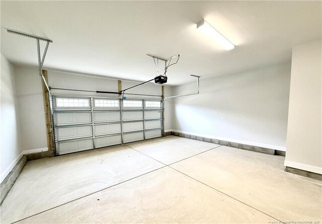 garage featuring baseboards and a garage door opener