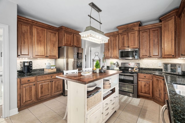 48 Falling Oak Ct, Clayton, NC 27520 - kitchen with appliances with stainless steel finishes, wooden counters, light tile patterned flooring, and decorative backsplash