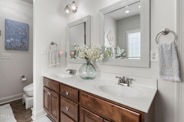 48 Falling Oak Ct, Clayton, NC 27520 - full bathroom featuring double vanity, toilet, baseboards, and tile patterned flooring