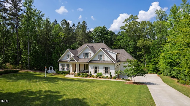 197 Boxwood Dr, Pittsboro, NC 27312 - craftsman house featuring concrete driveway, covered porch, and a front lawn