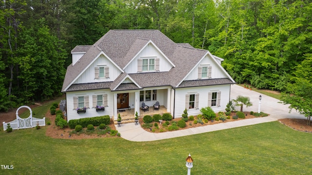 197 Boxwood Dr, Pittsboro, NC 27312 - view of front facade with a shingled roof, board and batten siding, and covered porch