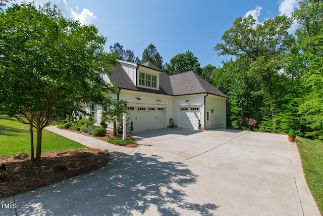 197 Boxwood Dr, Pittsboro, NC 27312 - view of front of home featuring driveway, an attached garage, roof with shingles, and a front lawn