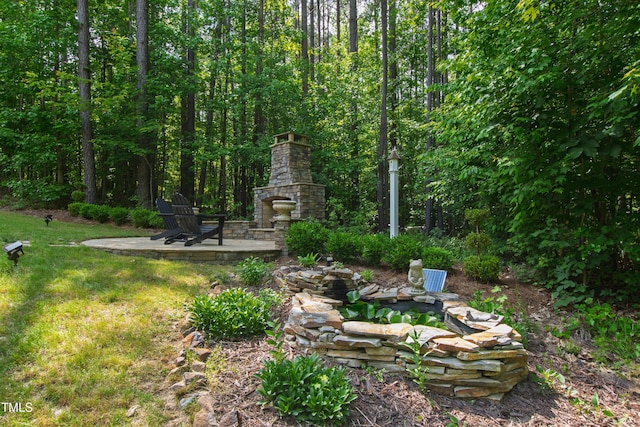 197 Boxwood Dr, Pittsboro, NC 27312 - view of yard featuring an outdoor stone fireplace and a patio