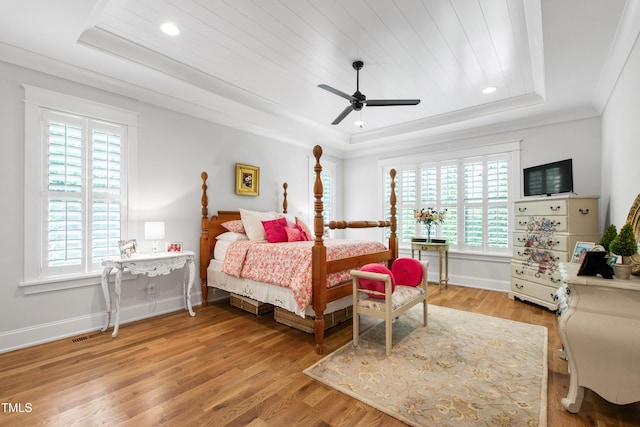 197 Boxwood Dr, Pittsboro, NC 27312 - bedroom with a raised ceiling, baseboards, light wood-style floors, ornamental molding, and ceiling fan
