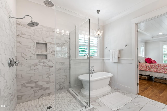 197 Boxwood Dr, Pittsboro, NC 27312 - ensuite bathroom with a shower stall, ornamental molding, a soaking tub, a chandelier, and wainscoting