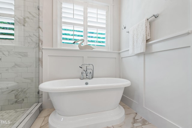 197 Boxwood Dr, Pittsboro, NC 27312 - bathroom with a stall shower, a soaking tub, marble finish floors, a decorative wall, and wainscoting