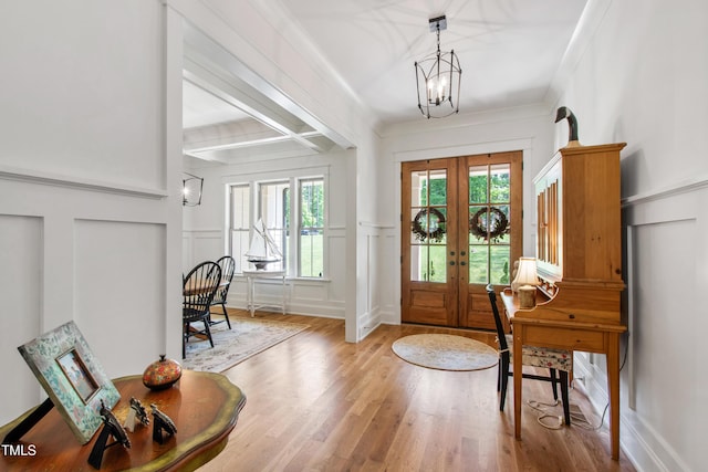 197 Boxwood Dr, Pittsboro, NC 27312 - entrance foyer with french doors, a decorative wall, a chandelier, wood finished floors, and beamed ceiling