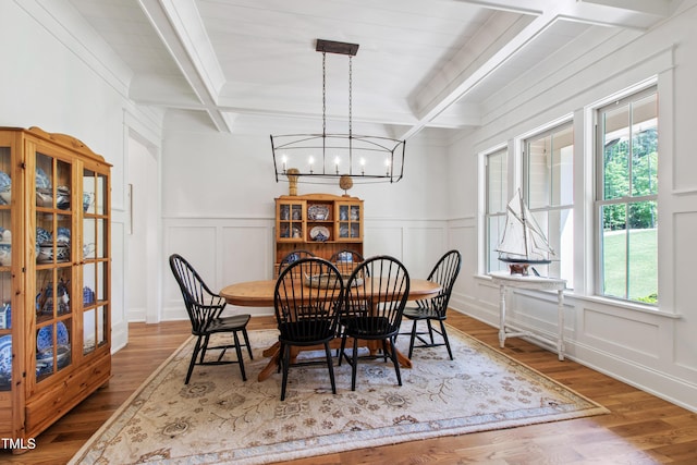 197 Boxwood Dr, Pittsboro, NC 27312 - dining area featuring a decorative wall, plenty of natural light, a chandelier, beamed ceiling, and wood finished floors