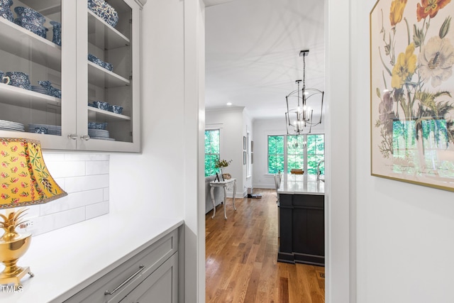 197 Boxwood Dr, Pittsboro, NC 27312 - corridor with light wood-style flooring, a chandelier, and ornamental molding