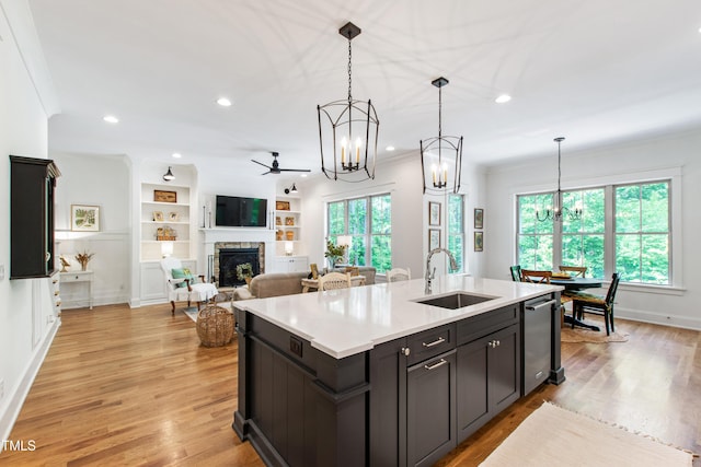 197 Boxwood Dr, Pittsboro, NC 27312 - kitchen featuring a sink, a chandelier, a fireplace, light countertops, and ceiling fan